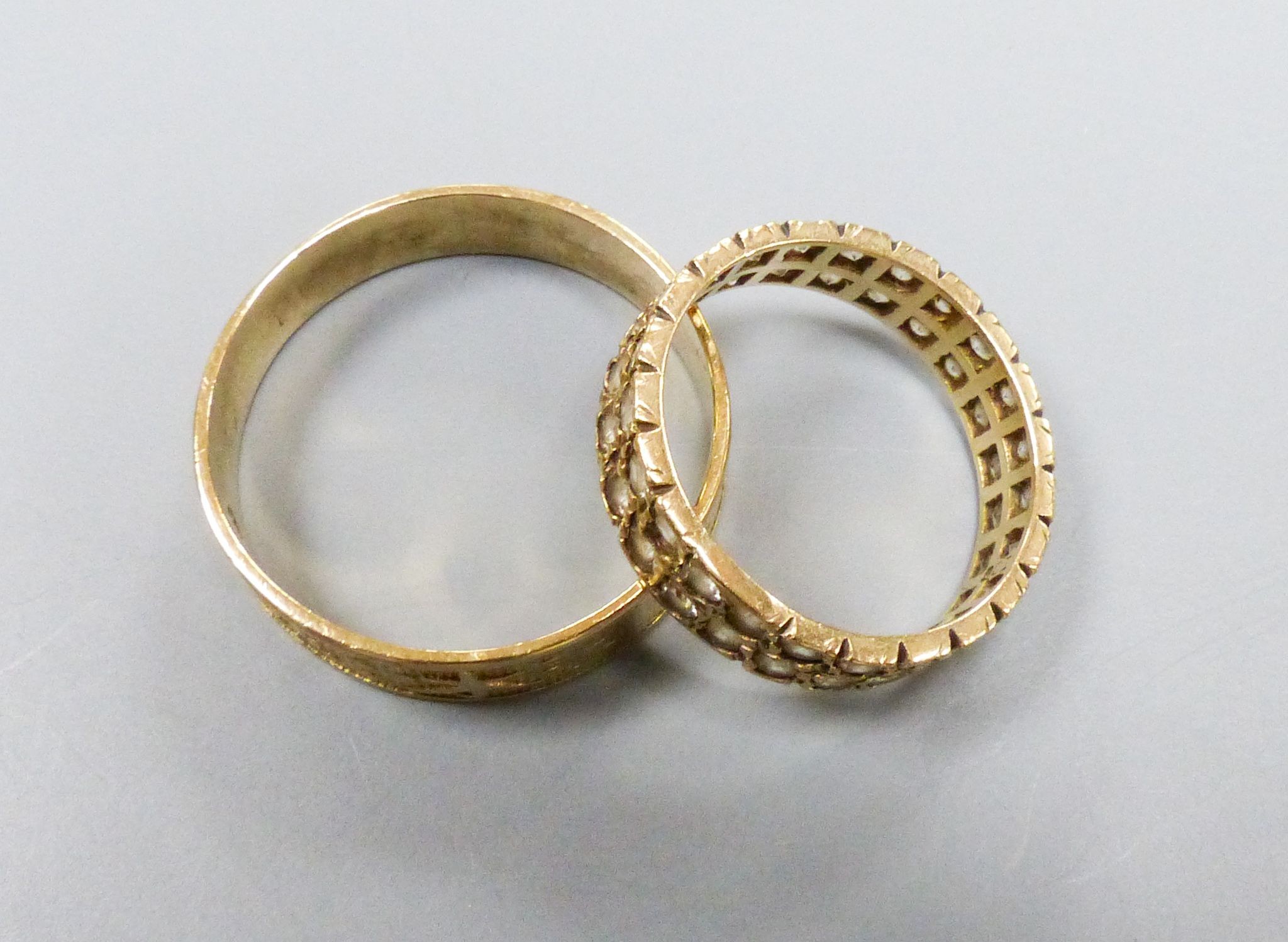 A Chinese yellow metal ring, size X, 3.1 grams and a paste-set 9ct gold ring, gross 2.6 grams.